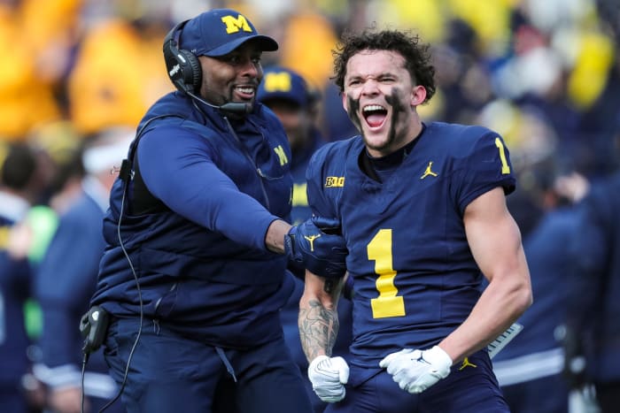Michigan receiver Roman Wilson and acting head coach/offensive coordinator Sherrone Moore celebrate Wilson's touchdown catch against Ohio State during the first half at Michigan Stadium in Ann Arbor